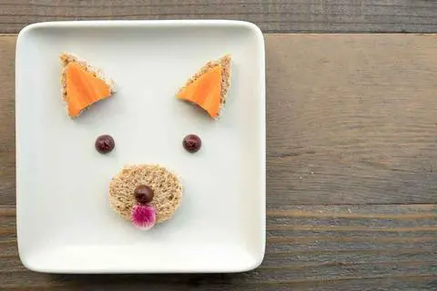 edible red panda facial features ready to add to a bowl of vegan carrot celery soup