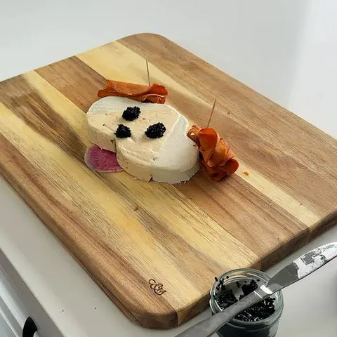 the vegan cheese dog with vegan caviar nose and eyes.