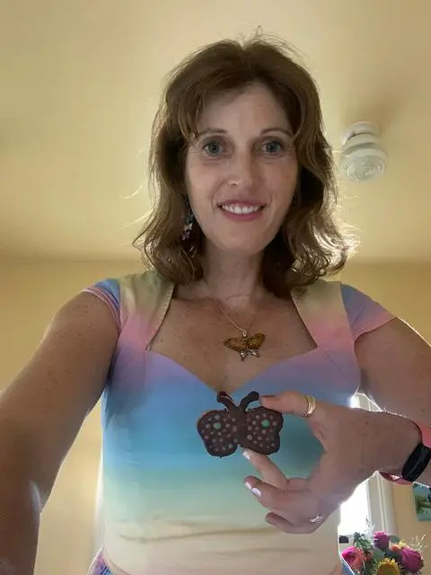 kimmy holding one of her vegan birthday chocolate peanut butter pretzels