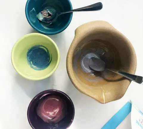 adding powdered vegan food coloring to melted vegan white chocolate