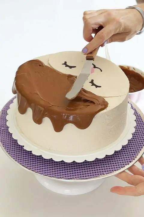 adding the biscoff drip to the cake.