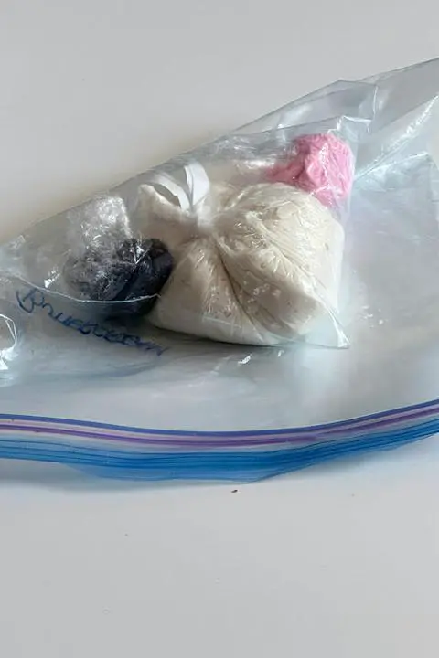 different colors of leftover frosting in a freezer bag