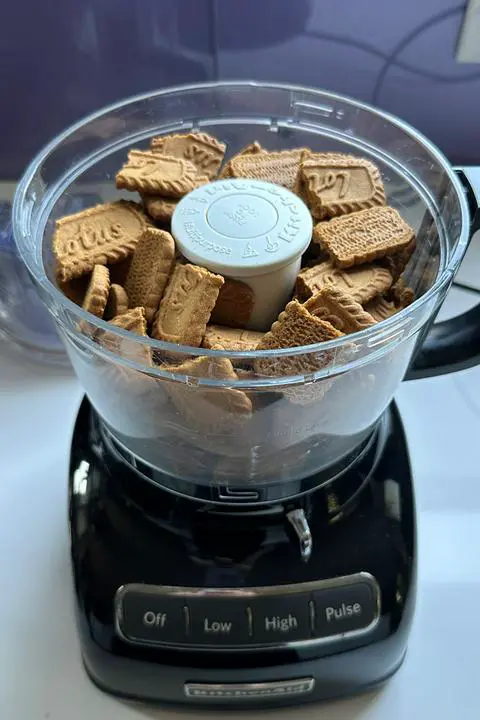 food processor filled with vegan lotus biscoff cookies.