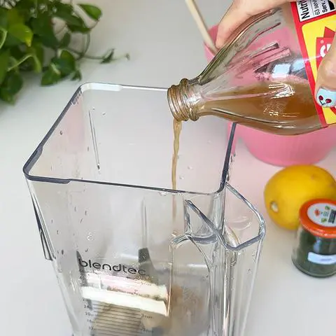 adding braggs apple cider vinegar to the blender.