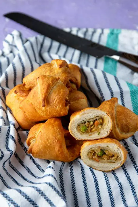 vegan cramosas with one cut open showing the inside of the stuffed croissant
