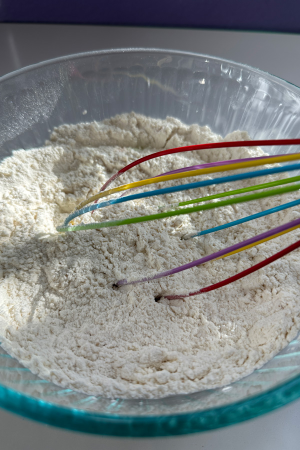 whisking the ingredients for vegan cold fermented detroit pizza dough