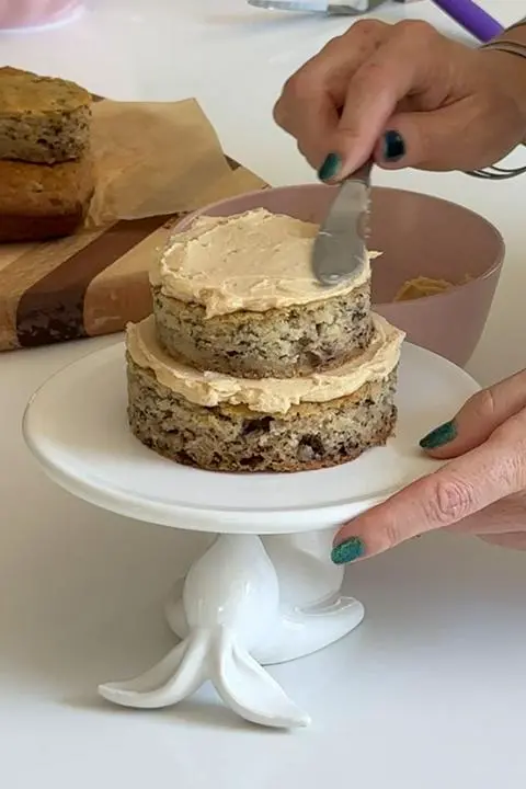 assembling the 3-tier dog birthday cake.