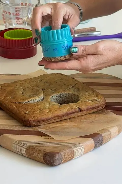 cutting 3 circles from the cake.