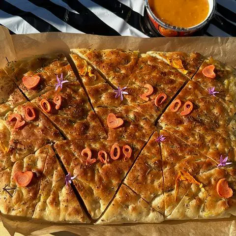 vegan focaccia bread decorated for a 2009 party and cut into pieces.