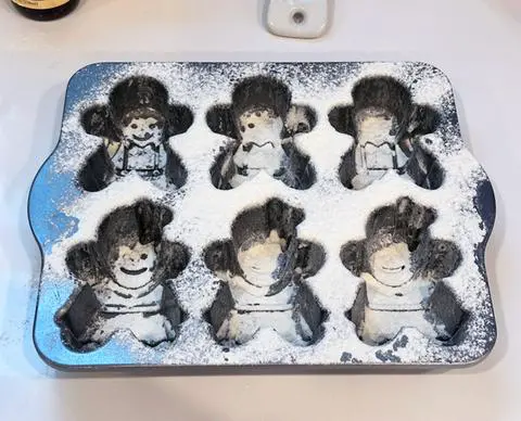 a gingerbread kids pan dusted with flour.