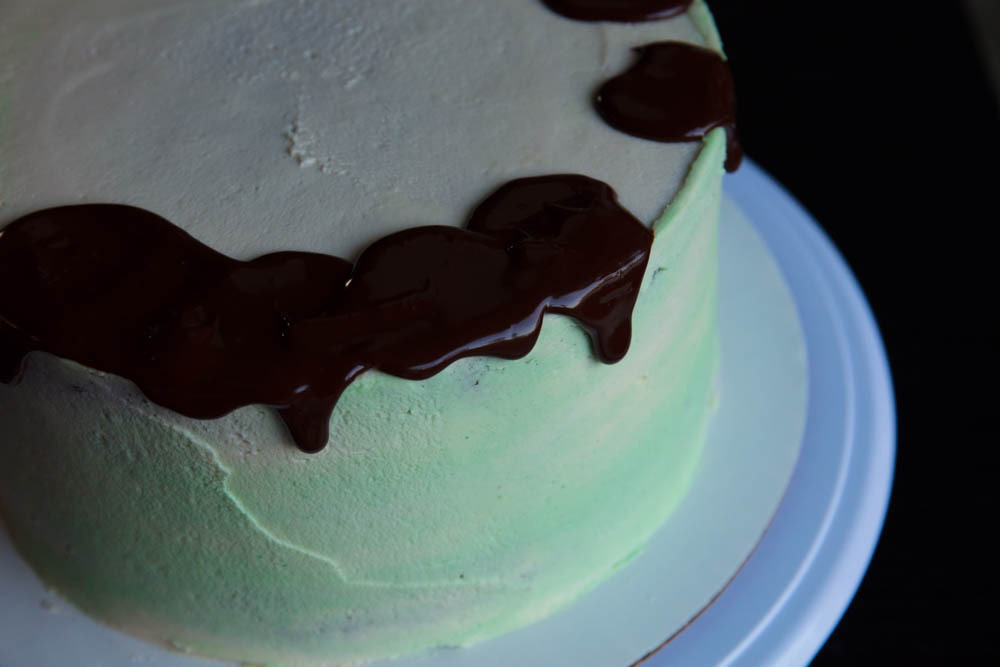 decorating cake with vegan ganache
