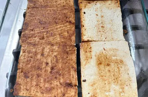 basting the other side of the vegan ham slices with vegan ham seasoning