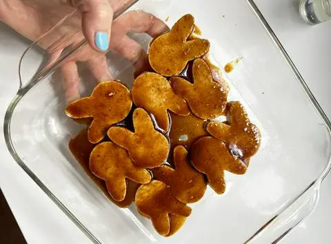 bunny-shaped tofu ham covered in ham seasoning marinade and ready to bake