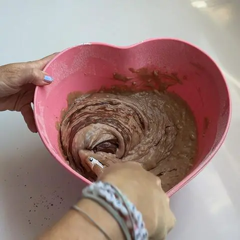 folding the bloomed cocoa into the cake batter.