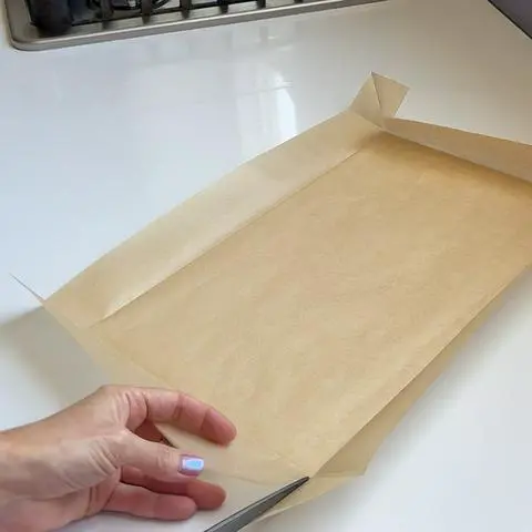 cutting the corners of the parchment paper.