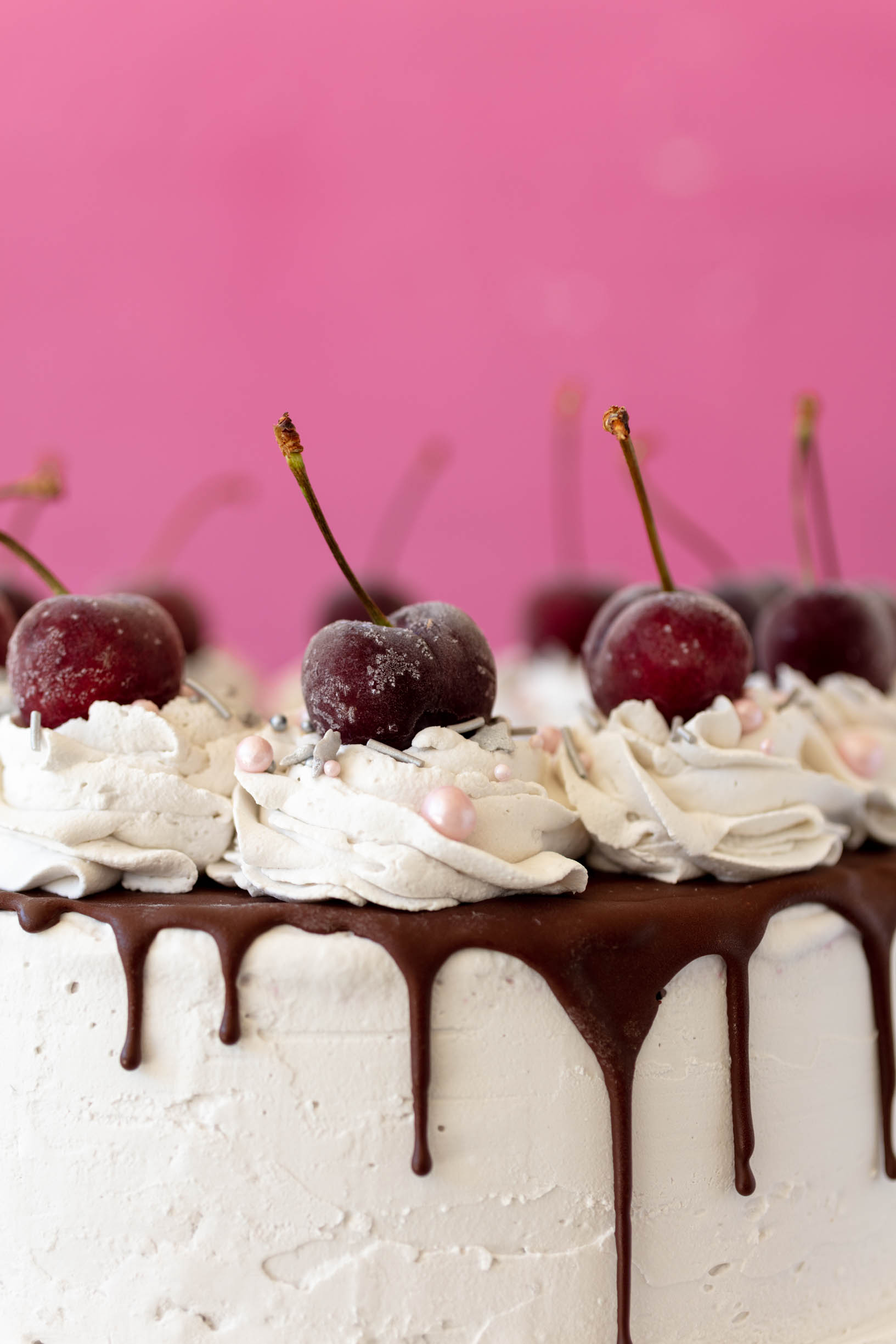 vegan ice cream cake with whipped cream and cherries on top