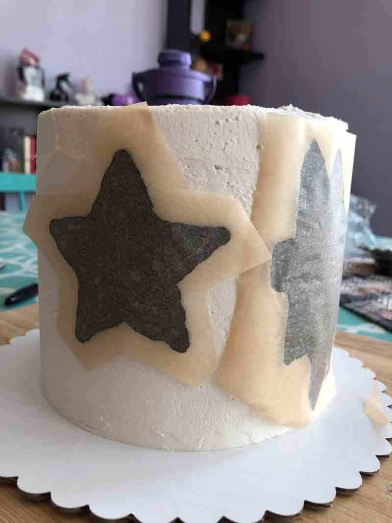 placing the vegan buttercream transfers onto the cake