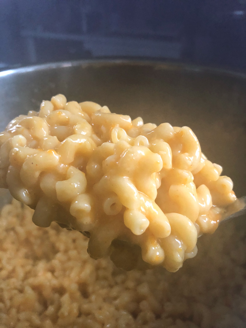 a scoop of the creamy mac and cheese after the vegan cheese melts into it