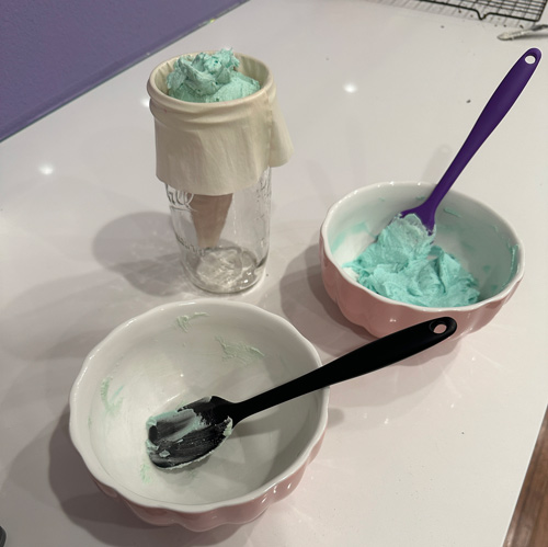 filling a piping bag with vanilla ombré frosting