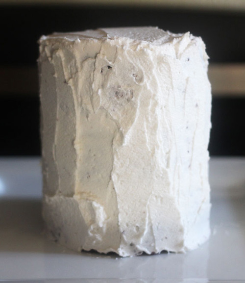 Stacked vegan chocolate cake with vanilla frosting