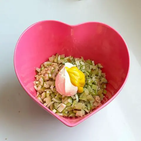 pink heart bowl with vegan tuna, celery, pickle, vegan mayo, and mustard.