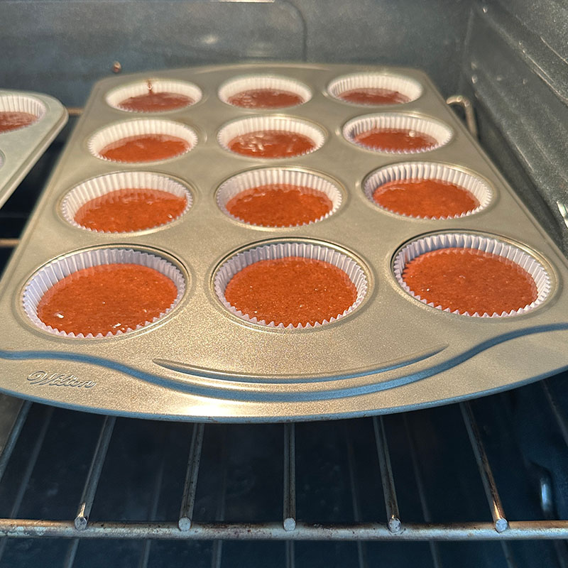 12 vegan and gluten-free chcoolate cupcakes in the oven baking.