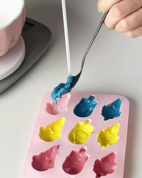 coating the bottom and sides of the cubbies in a silicone mold.