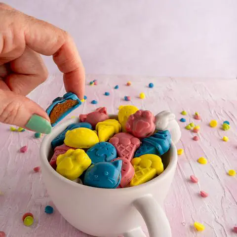 holding a peanut butter cup that has been cut showing the peanut butter filling.