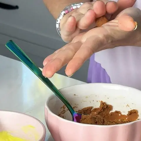 rolling a ball of peanut butter filling between hands.