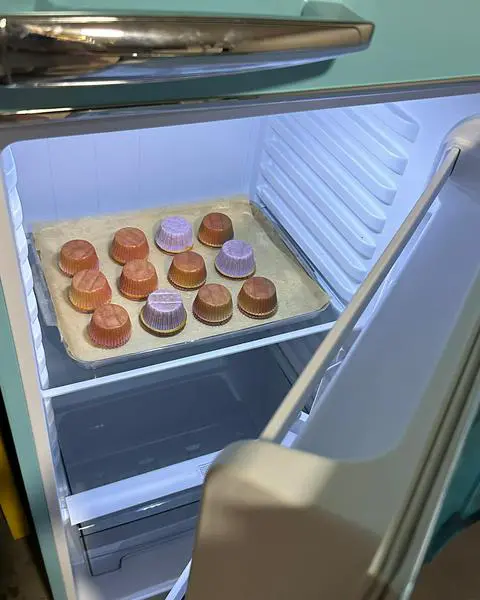 a tray of upside down cupcakes in a fridge.