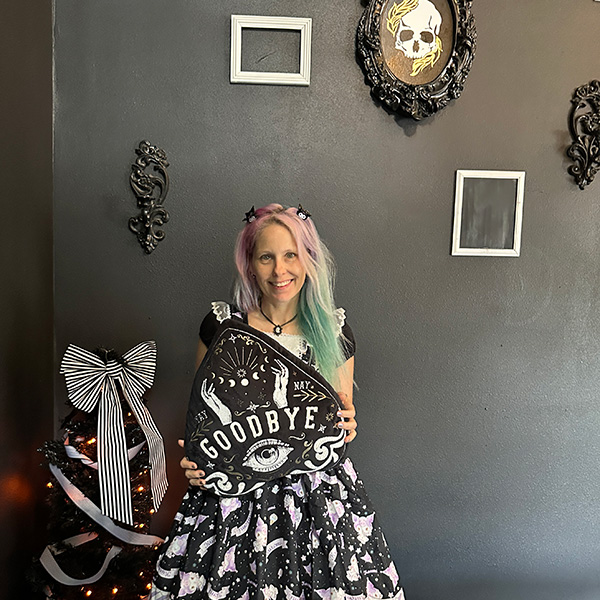 me holding a ouija board pillow at Memento Mori in Portland.