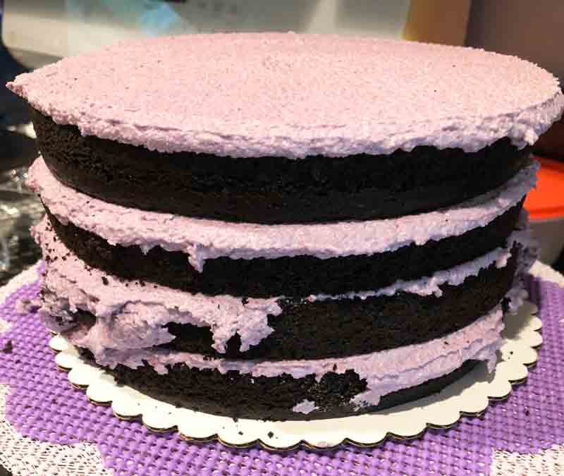 assembling the vegan organic blackberry chocolate cake