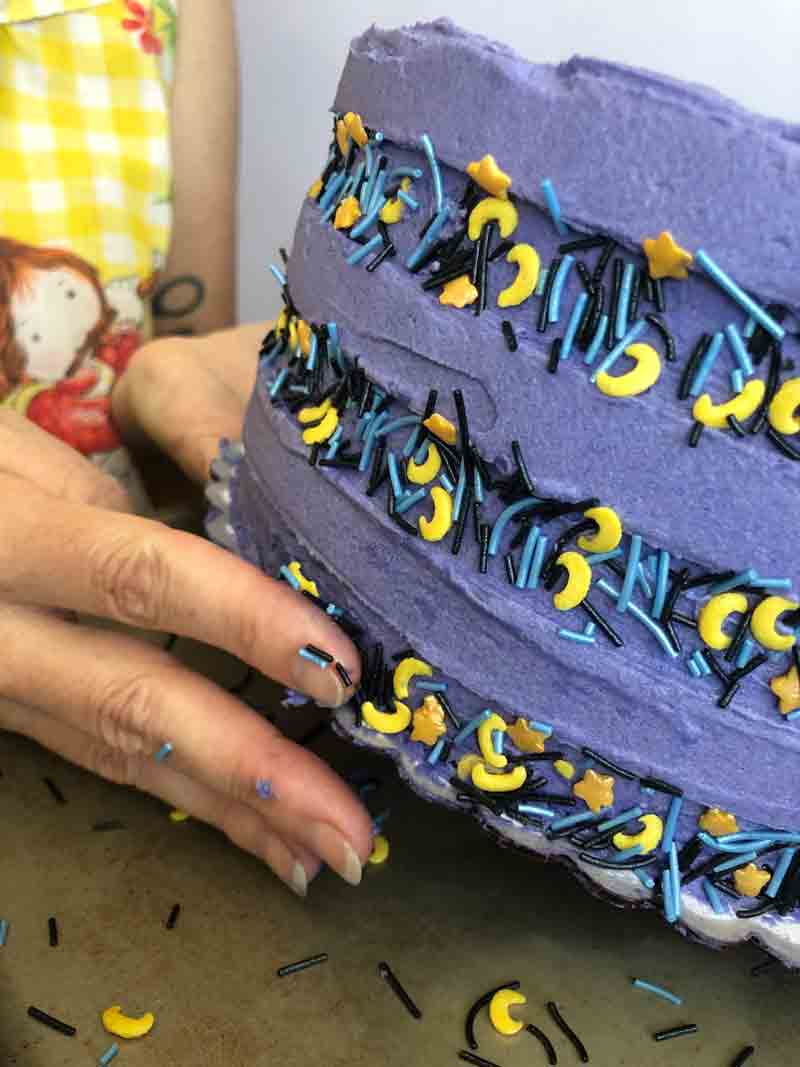 decorating the vegan organic blackberry chocolate cake