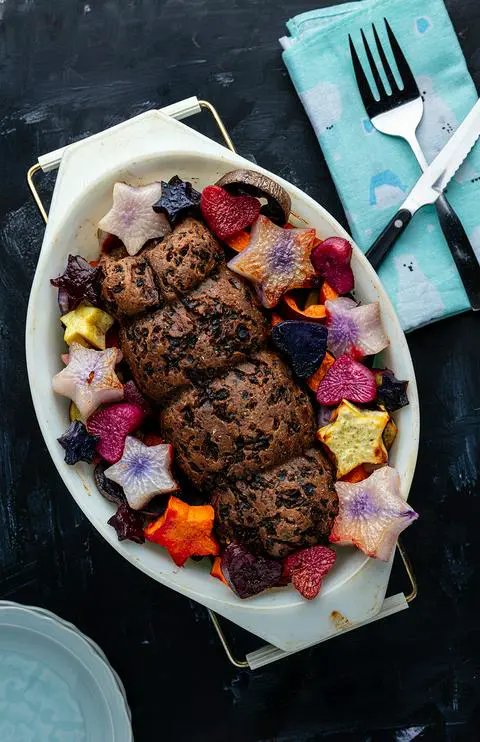 a vegan roast beef with roasted veggies ready to serve.