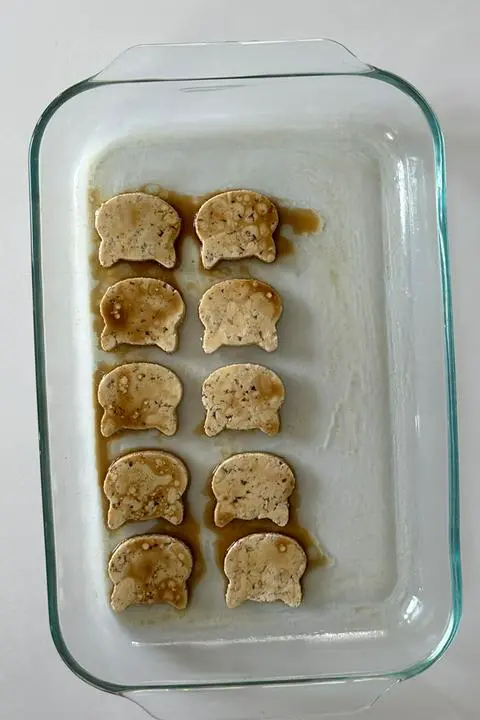 tofu cats covered in marinade and ready to bake