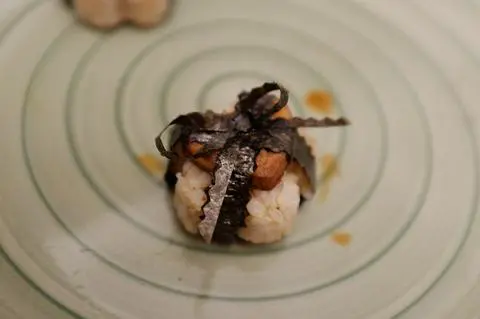 vegan spam musubi wrapped with the strip of a nori sheet in a bow