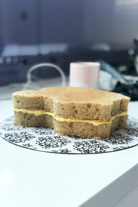 two layers of vegan vanilla cake with frosting between the layers